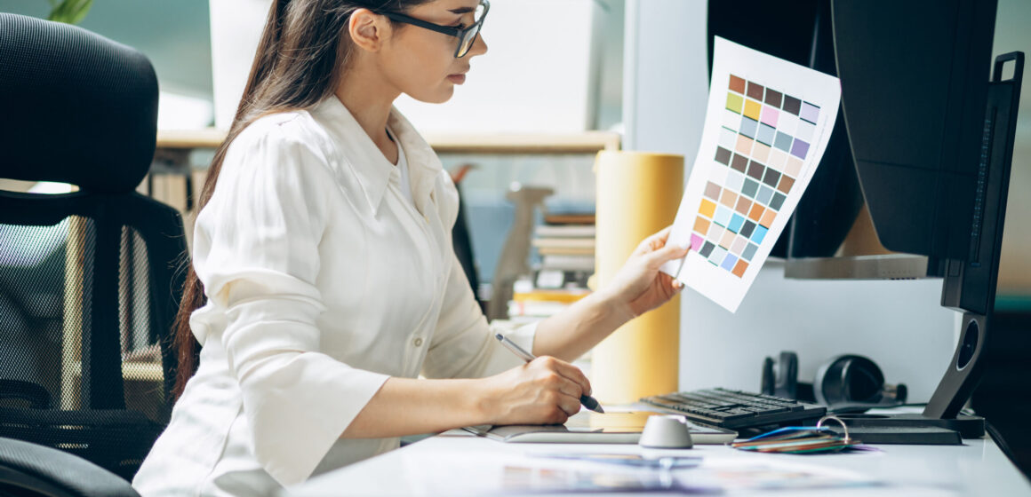 Female digital designer looking at swatches at an office