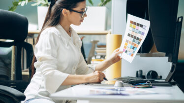 Female digital designer looking at swatches at an office